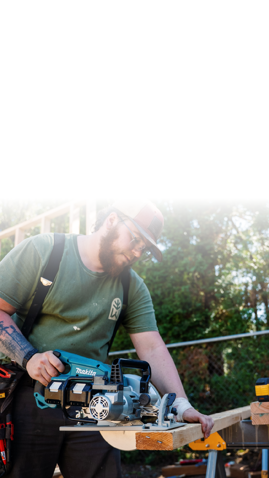 Carpenter cutting a wooden beam on a Portland Metro home renovation jobsite